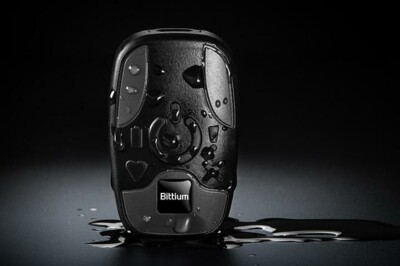 Bittium waterproof ECG device with water droplets, displayed on a dark surface with reflective water.